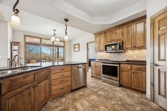 kitchen with a sink, brown cabinets, stainless steel appliances, and backsplash