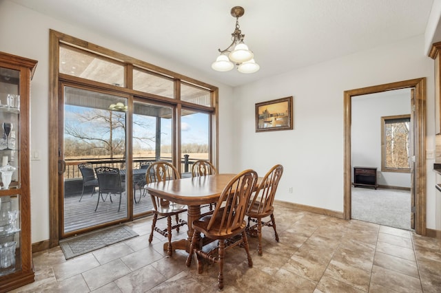 dining space with a notable chandelier and baseboards