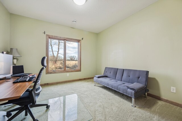 carpeted home office featuring baseboards