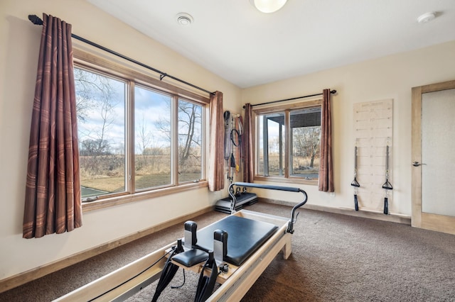 exercise room with carpet flooring and baseboards