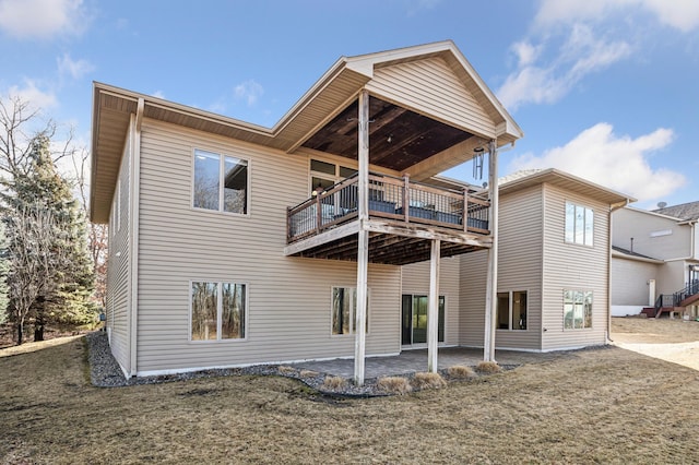 rear view of property featuring a deck and a patio