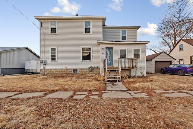 exterior space with an outbuilding and a detached garage