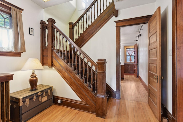 stairs with wood-type flooring and baseboards