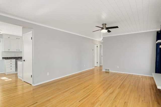 unfurnished living room with light wood finished floors, ornamental molding, visible vents, and baseboards