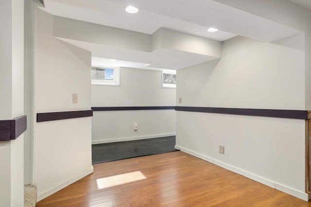 basement with recessed lighting, wood-type flooring, and baseboards