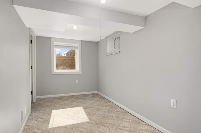 empty room featuring carpet flooring, visible vents, and baseboards