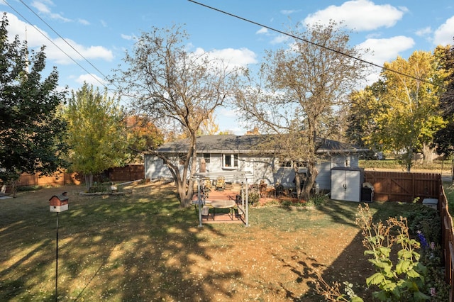 back of house with a fenced backyard and a lawn