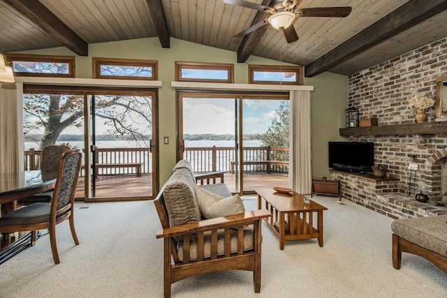 sunroom / solarium featuring lofted ceiling with beams, wooden ceiling, and a ceiling fan