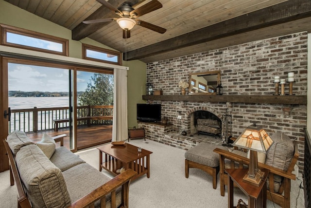 living area with vaulted ceiling with beams, wooden ceiling, carpet floors, brick wall, and a ceiling fan