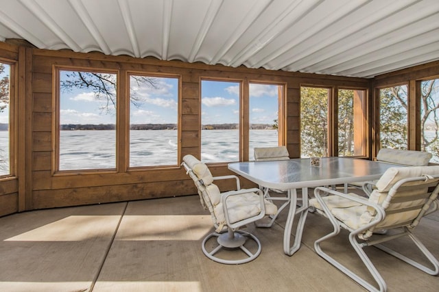 sunroom with plenty of natural light and a water view