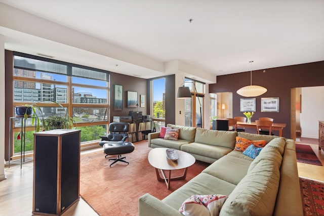 living room with a wall of windows and a city view