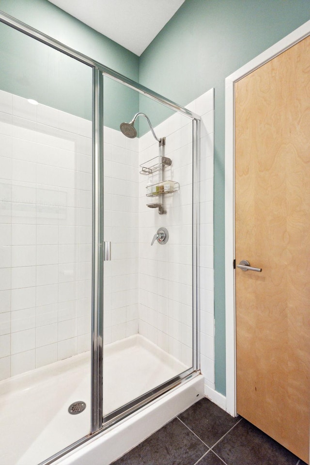 full bathroom featuring a stall shower and tile patterned floors