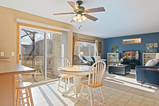 dining area featuring a ceiling fan and tile patterned floors