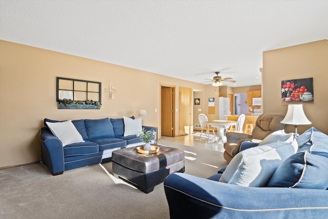 living room with ceiling fan and carpet flooring