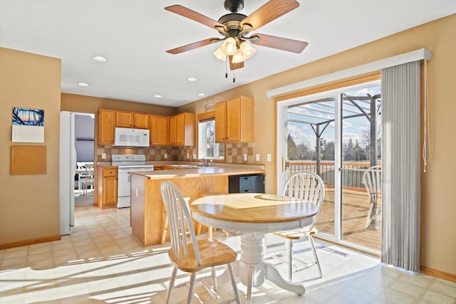 dining area featuring recessed lighting, baseboards, ceiling fan, and light floors