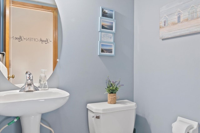 bathroom featuring toilet and a sink