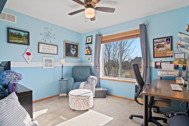 office area with a ceiling fan, visible vents, carpet floors, and baseboards