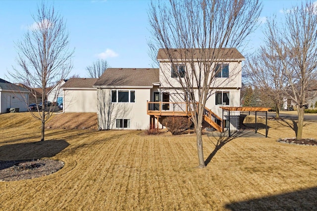 rear view of house featuring stairs, a yard, and a wooden deck