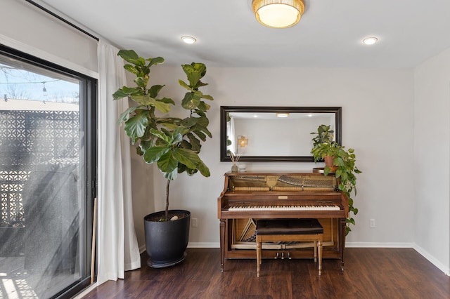 living area featuring baseboards and wood finished floors