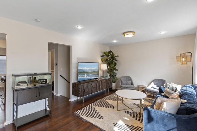 living area with recessed lighting, wood finished floors, and baseboards