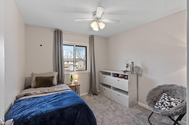 bedroom with ceiling fan, baseboards, and light colored carpet