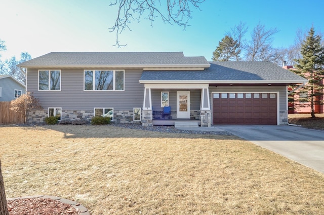 view of front facade featuring concrete driveway, covered porch, a garage, stone siding, and a front lawn