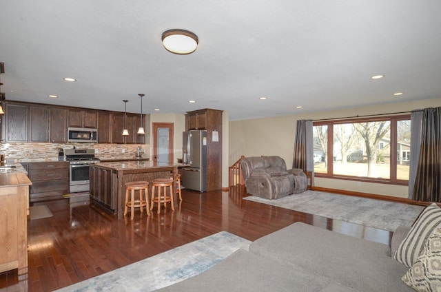 living area featuring dark wood-type flooring and recessed lighting