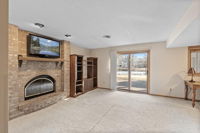 unfurnished living room with baseboards, visible vents, a textured ceiling, a brick fireplace, and carpet flooring