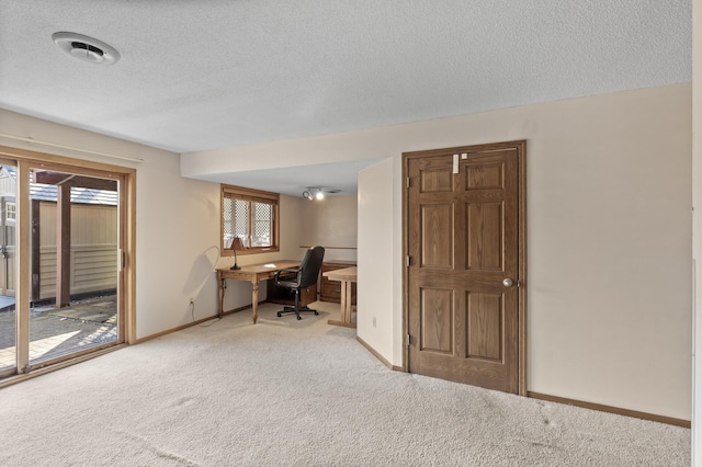 office area featuring baseboards, carpet floors, a textured ceiling, and visible vents