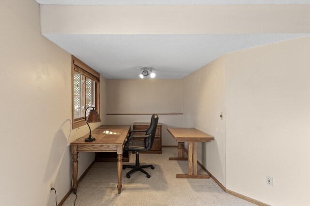 carpeted office space featuring baseboards