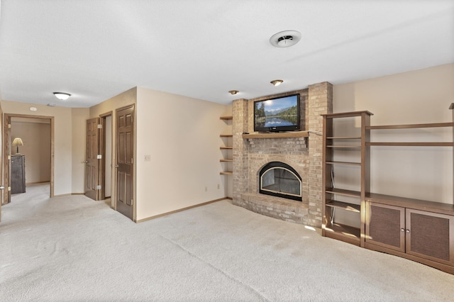 unfurnished living room featuring a fireplace, baseboards, and carpet floors