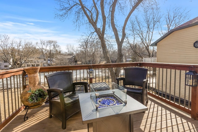 wooden terrace featuring an outdoor fire pit