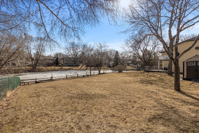 view of yard featuring an outdoor structure and fence