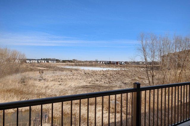 view of yard with a water view and fence