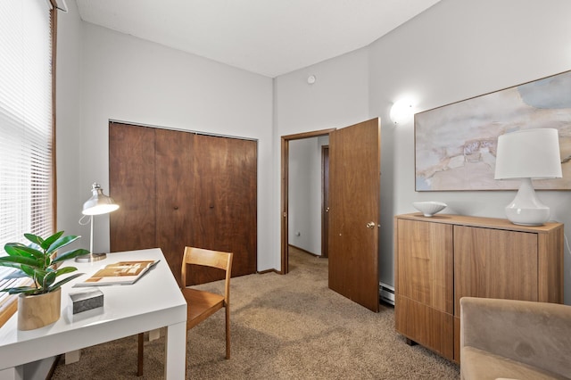 office with light carpet, a healthy amount of sunlight, and a baseboard heating unit