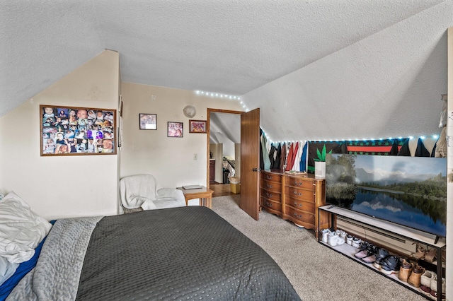 bedroom with vaulted ceiling, carpet floors, and a textured ceiling