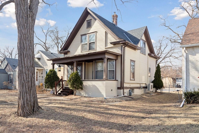 view of front facade with fence and roof with shingles