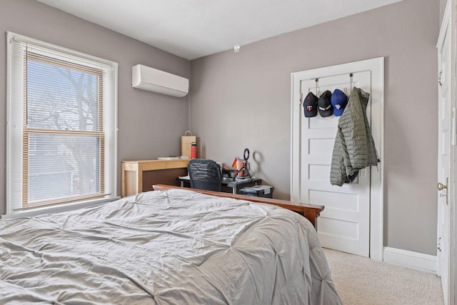 bedroom with carpet floors, a wall mounted air conditioner, and baseboards