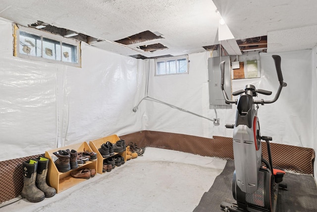 below grade area featuring electric panel and a textured ceiling