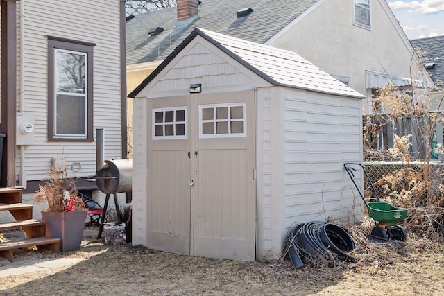 view of shed with fence