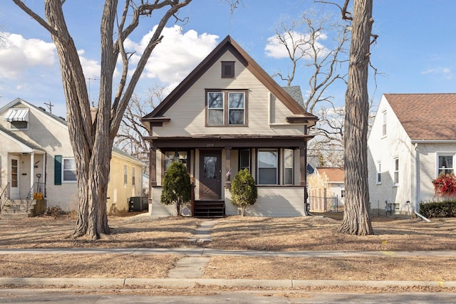 bungalow-style house featuring central air condition unit and covered porch