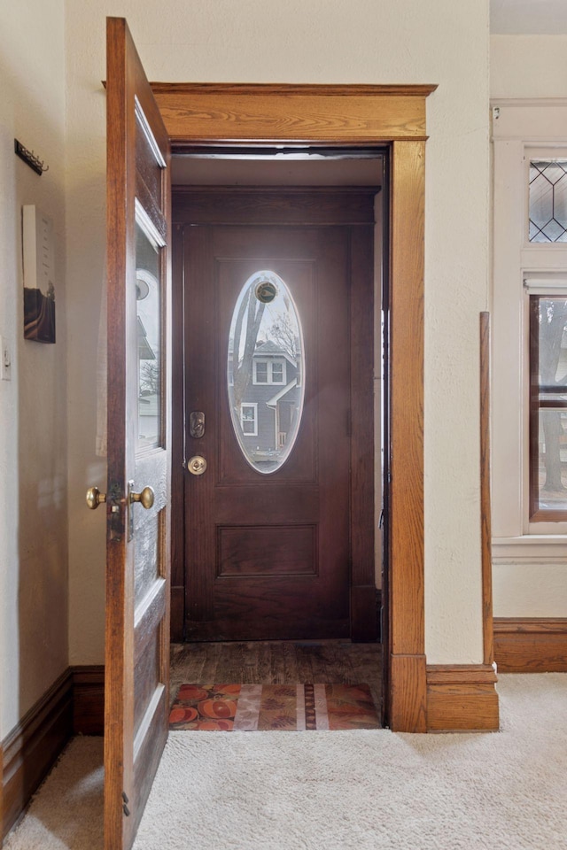 doorway to outside featuring carpet