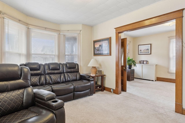 living area featuring carpet flooring and baseboards