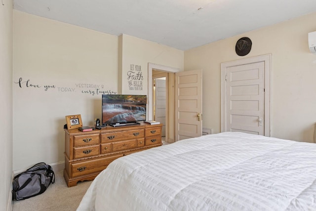 carpeted bedroom featuring baseboards and an AC wall unit