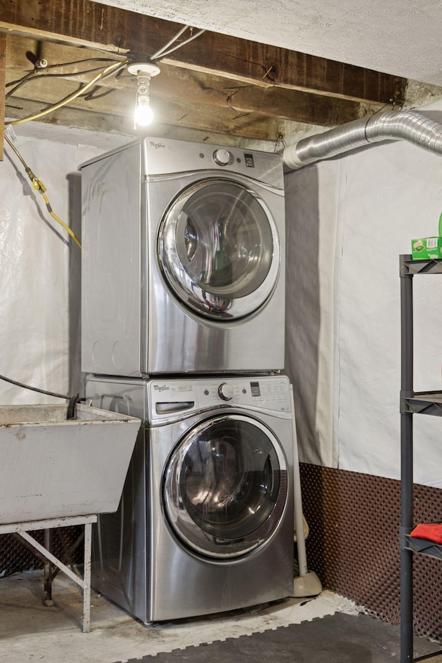 laundry room featuring stacked washing maching and dryer and laundry area