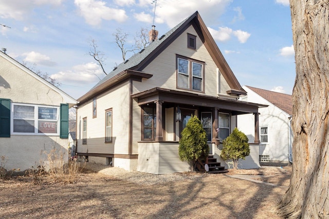 view of front of home with covered porch and a chimney