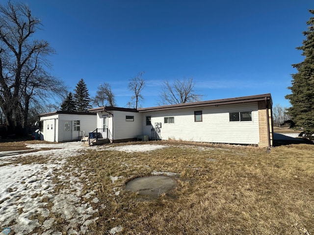 rear view of property with an outbuilding