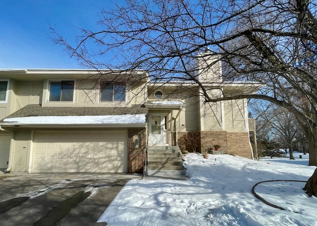 view of front of property with driveway, brick siding, an attached garage, and roof with shingles