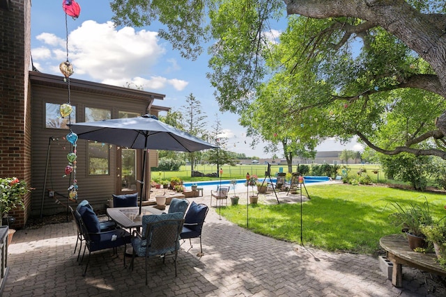 view of patio / terrace with fence, a fenced in pool, and outdoor dining space