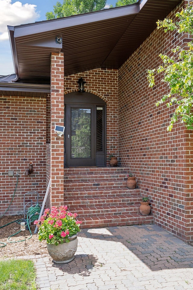 property entrance featuring brick siding